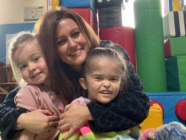 Mum and two daughters in the soft play